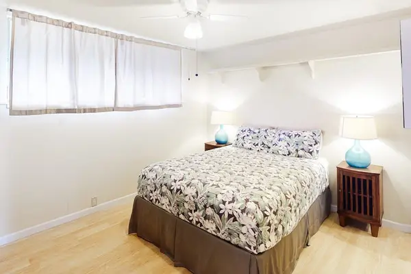 Comfortable queen bed with crisp white linens and soft pillows