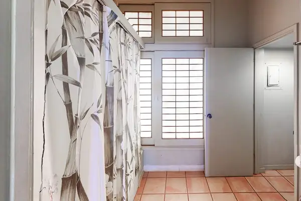 Clean full bathroom designed for comfort with practical amenities and fresh towels