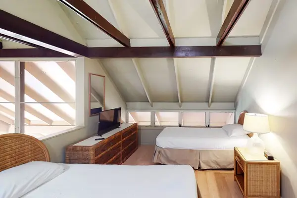 Inviting second bedroom featuring two beds for flexible sleeping arrangements during stays