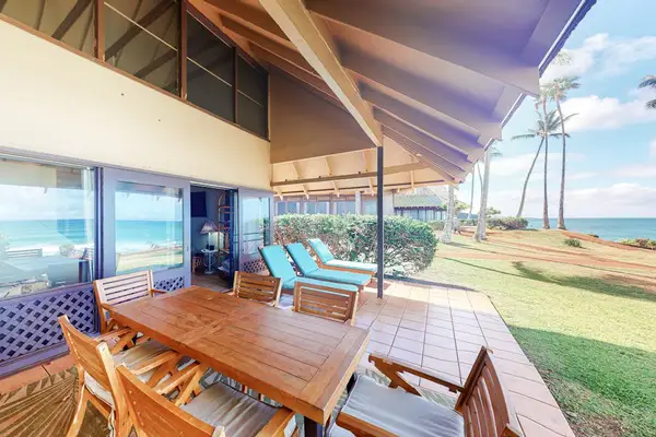 Tropical grounds surround the home with palms pathways and sunshine