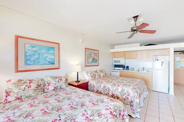 Comfortable studio sleeping area features double beds and ceiling fans