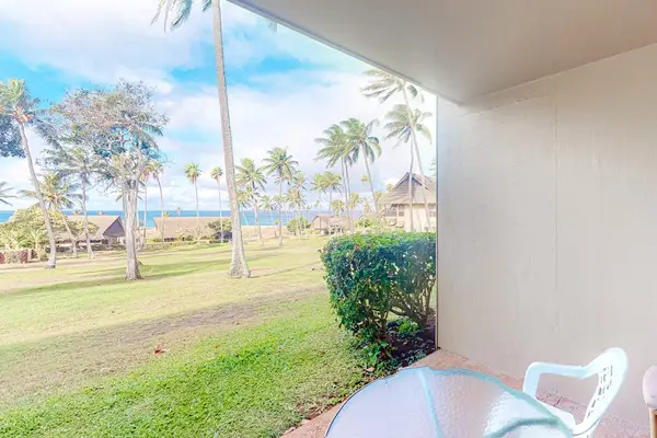 Covered lanai seating enjoys peaceful views across tropical resort grounds