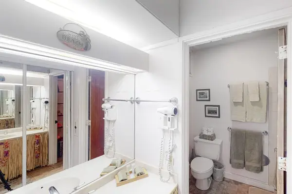 Bright bathroom features vanity mirror shower and clean contemporary finishes