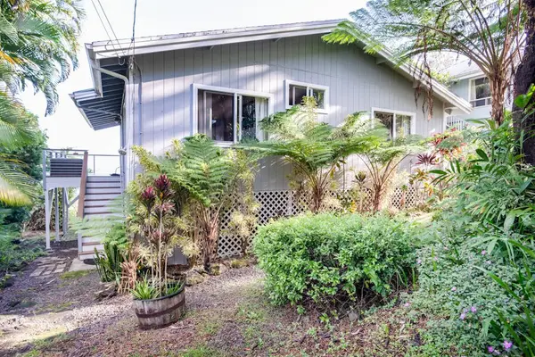 Side Exterior View showing Lush Tropical Landscaping & Entry Stairs