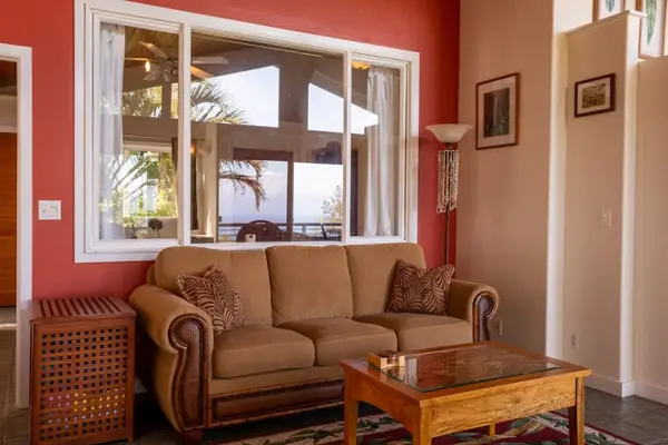 Cozy Living Area with Plush Sofa, Warm Accent Wall & Natural Light