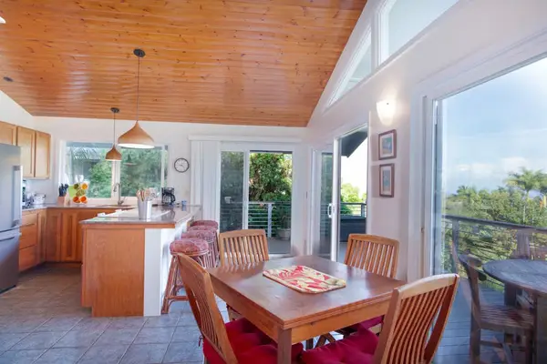 Open Layout Kitchen with Breakfast Bar Seating & Adjacent Dining Area