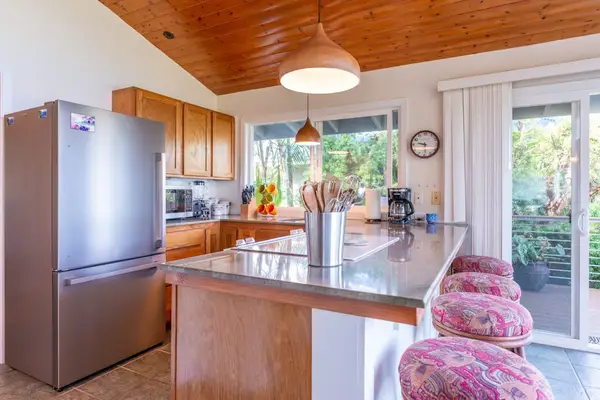 Fully Equipped Kitchen with Stainless Steel Refrigerator & Prep Counter