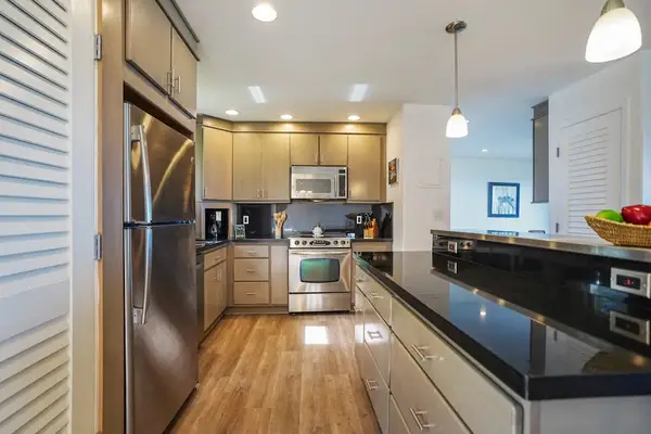 Modern kitchen with dark cabinetry and ample counter space