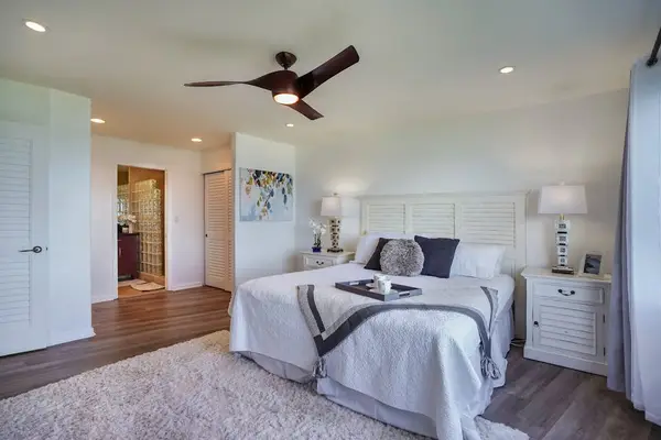 Comfortable bedroom with a ceiling fan and soft natural light