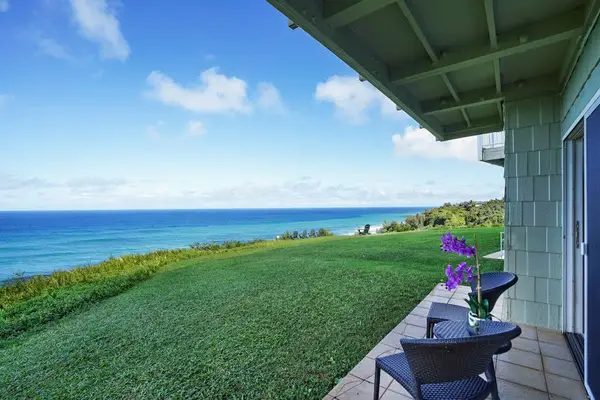 Oceanfront lawn with lounge seating and sweeping coastal views