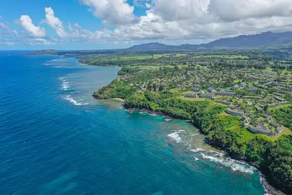 Bird's-eye view of the rugged coastline and clear blue waters