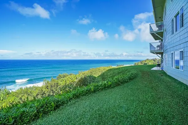 Expansive oceanfront lawn with sweeping views of the coastline