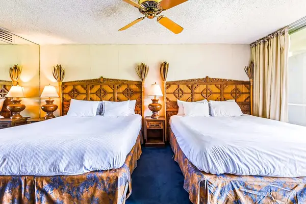 Perfect for families or groups, this bedroom offers two plush king beds.