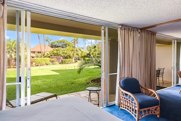 Enjoy direct access to the lush tropical lawn from your garden-view bedroom.