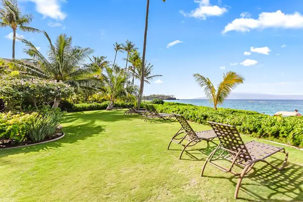 Unwind on the lush oceanfront lawn with peaceful island views.