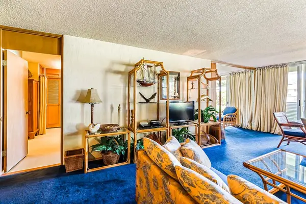 Relax in the bright living room featuring a convenient sofa bed for extra guests.