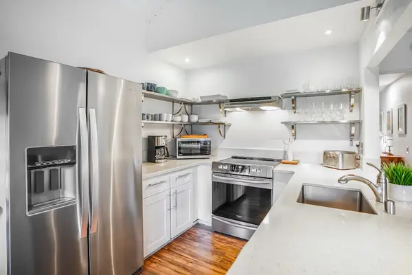 Bright kitchen with generous counter space and stainless steel appliances.