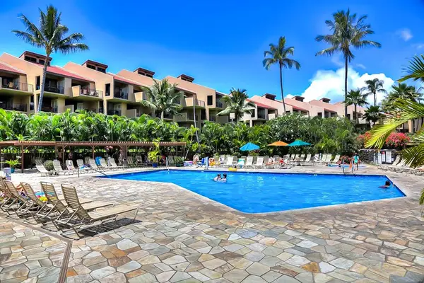 Refreshing resort pool surrounded by tropical scenery