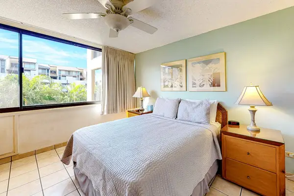 Cozy primary bedroom with bedside lamps creating a warm and relaxing atmosphere