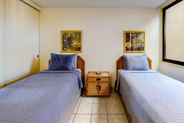Charming twin bedroom with a convenient nightstand between the beds