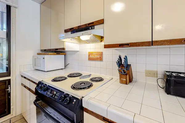 Well-equipped kitchen with ample cabinet storage, cookware, and convenient appliances