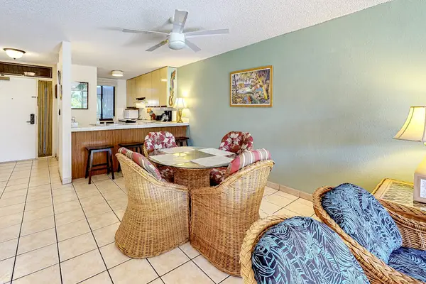 Cozy dining area and kitchen with charming rustic touches and island-inspired style