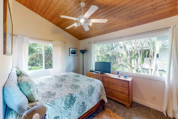 Spacious Primary Suite with Vaulted Ceiling, Dresser, & Garden Views