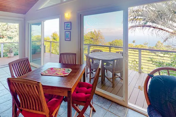 Dining Nook with Sliding Glass Doors opening to Oceanfront Balcony