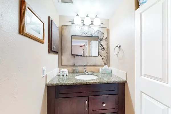 Modern Bathroom Vanity with Granite Countertop, Mirrored Cabinet, and Bright Lighting