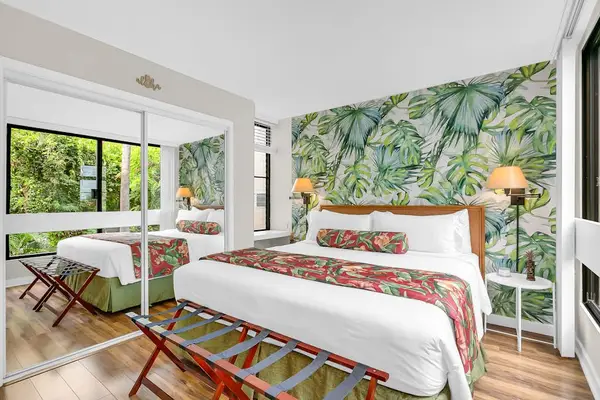 Primary Bedroom with Mirrored Closets & Lush Tropical Decor