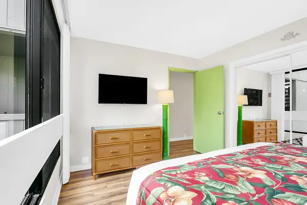 Bedroom Setup with Wall-Mounted TV & Ample Dresser Storage