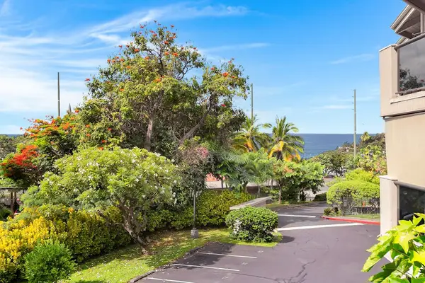 Lush Property Exterior & Surrounding Landscape with Distant Ocean View