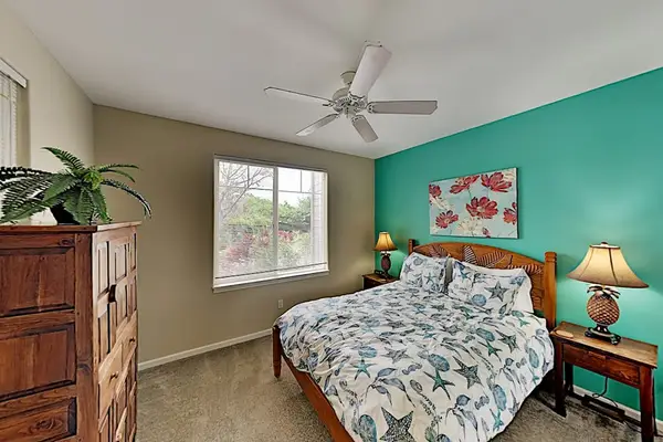 Guest bedroom with queen bed and a fan for your nightly comfort.