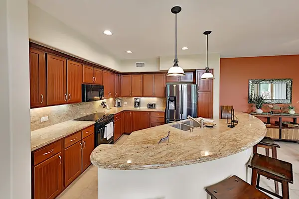 Large island for extra counter space and four barstools for extra seating.