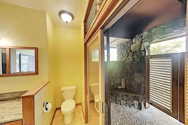Bright Bathroom With Outdoor Shower Access