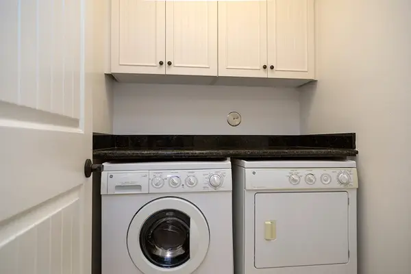 In-Unit Laundry Nook with Washer, Dryer & Overhead Storage