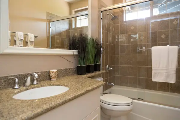 Guest Bath featuring Granite Vanity & Tub/Shower Combination