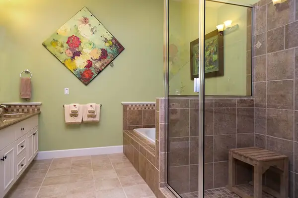 Primary En-Suite Bath featuring Walk-In Glass Shower & Soaking Tub
