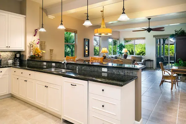 Gourmet Chef's Kitchen featuring Dark Granite Countertops & Breakfast Bar