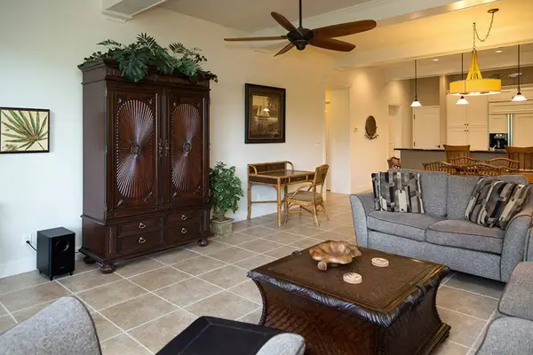 Spacious Living Room with Comfortable Seating & Elegant Armoire
