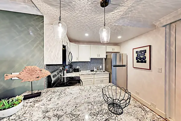 Compact kitchen offers practical cabinetry, cooking appliances, and counter space
