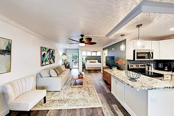 Open living area showcases sofas, dining space, and practical furnishings