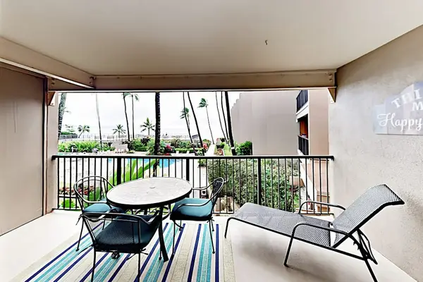 Covered balcony offers outdoor seating, ocean views, and tropical breezes