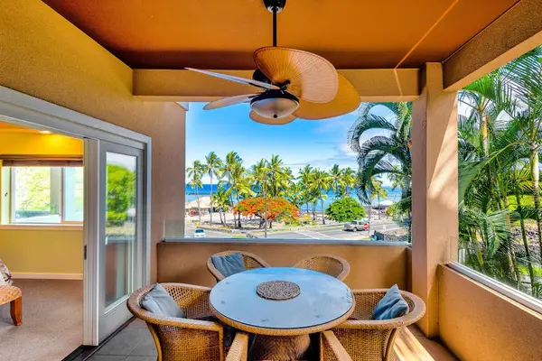 Covered Balcony Dining Area with Ceiling Fan and Scenic Views