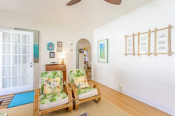 Unwind in the bright living room with refreshing airflow from overhead fans