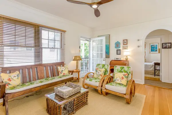 Relax beneath the ceiling fan in this cozy and inviting living room