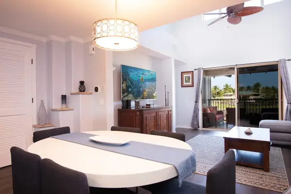 open-plan dining and living space featuring a round white dining table.