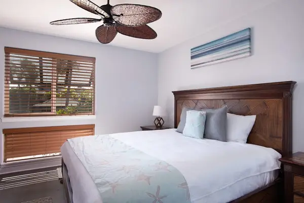 Guest bedroom with king bed and a ceiling fan for complete comfort.