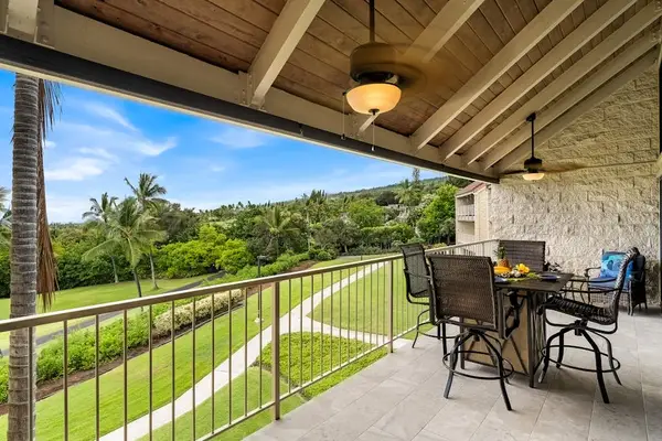 Enjoy the tropical breeze from the covered balcony featuring sweeping hillside views