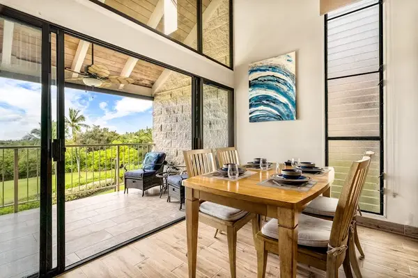 A beautiful dining area setup perfect for enjoying home-cooked meals with a tropical view